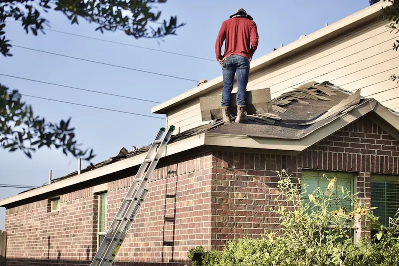 Professional roofer working on a residential roof in Meyersville